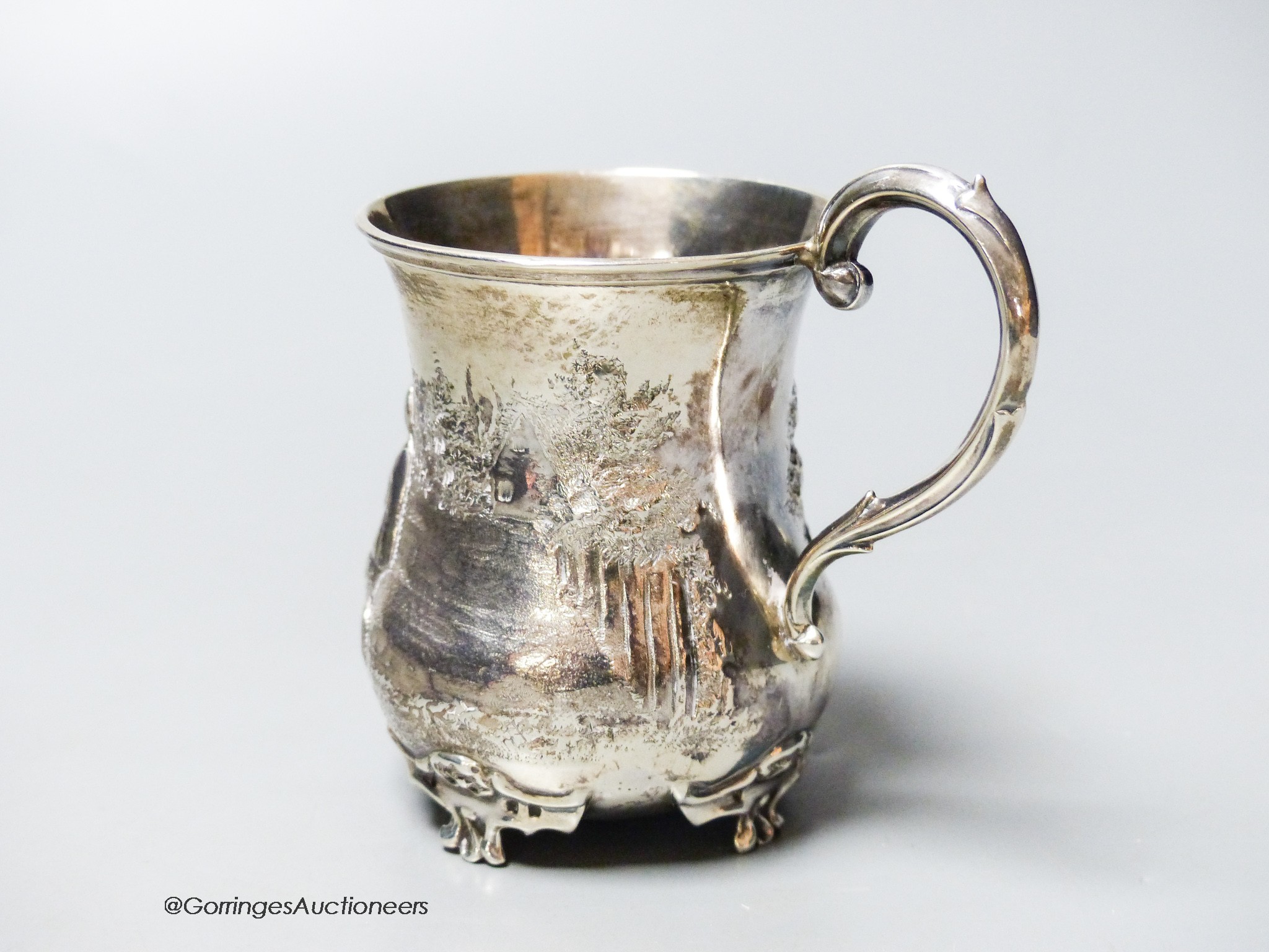 A Victorian silver christening mug, embossed with children and a wheelbarrow, George John Richards, London, 1855, 87mm, 83 grams.